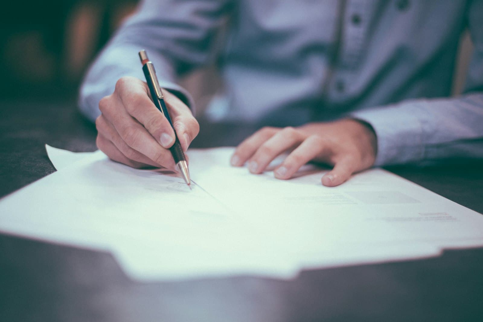 Business paperwork being reviewed and signed during company setup in Thailand.