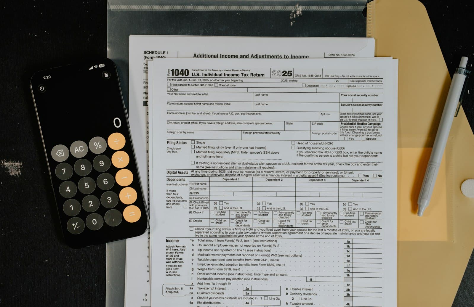 Tax compliance documents and calculator prepared for monthly filing work.